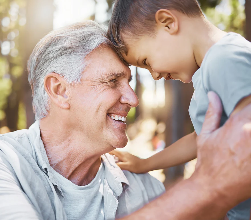 Happy grandfather looking into child's eyes