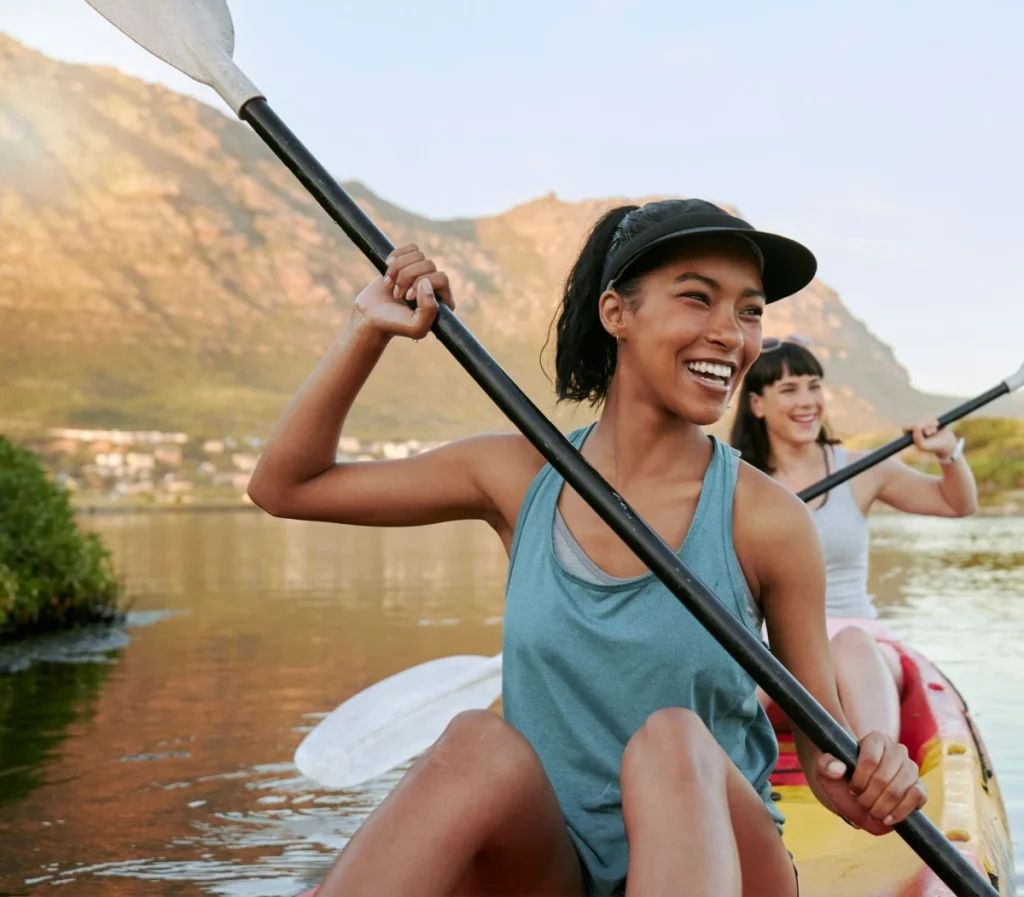 young woman kayaking without needing glasses